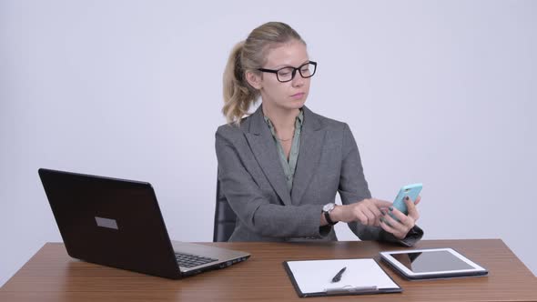 Young Happy Blonde Businesswoman Video Calling at Work