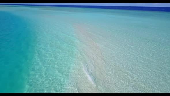 Aerial drone tourism of idyllic tourist beach journey by blue green ocean with white sandy backgroun