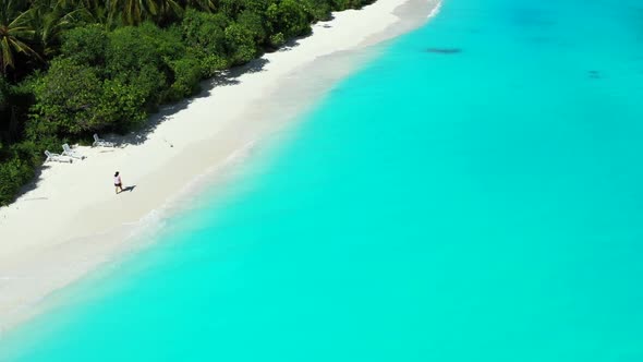 One girl enjoys life on marine coastline beach time by aqua blue sea with white sandy background of 