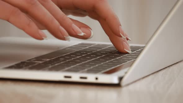 Female hands typing on notebook keyboard. Studying working with laptop online education