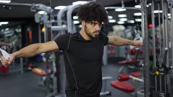 Curly Guy Exercising on Multistation at Gym for Arm and Shoulders Muscles Slow Motion