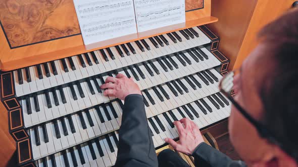 Organist Plays Music on Church Organ