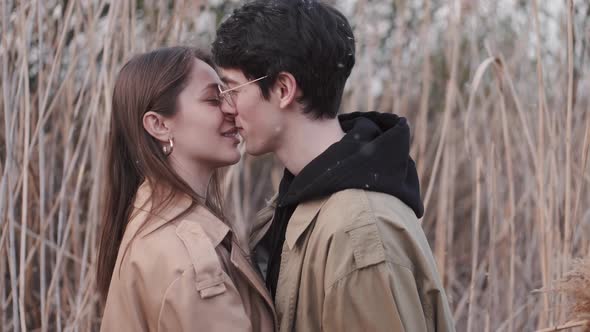 Boy in Glasses and Girl Kissing and Having Date in Reeds