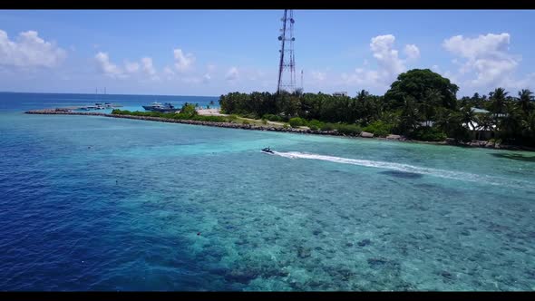 Aerial nature of marine coast beach holiday by blue green water with white sandy background of a day