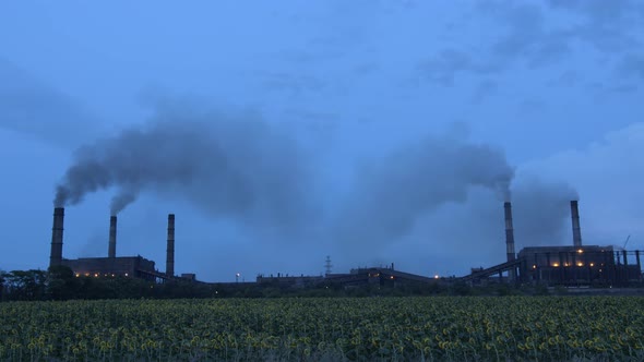 Timelapse of Clouds of Smoke Billowing From Smokestacks Into the Twighlight Sky, .