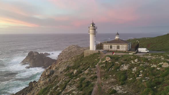 Amazing drone aerial sea landscape view of Cape Tourinan Lighthouse, in Spain at sunset