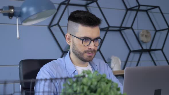 European Male Businessman Working At A Computer Laptop Online In A Bright Cozy Room At Home