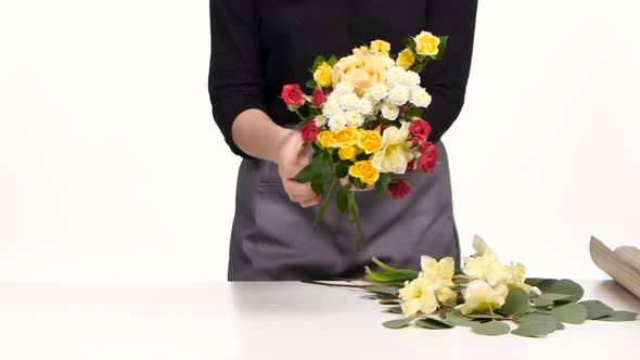 Florist Adds of Flowers in the Bouquet. White. Slow Motion. Close Up