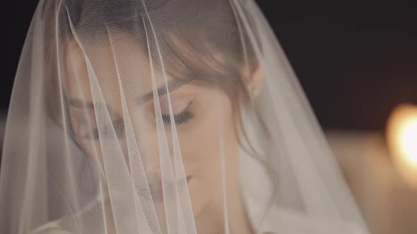 Bride in Boudoir Dress Under Veil and in a Silk Robe Wedding Morning Woman in Night Gown and Veil