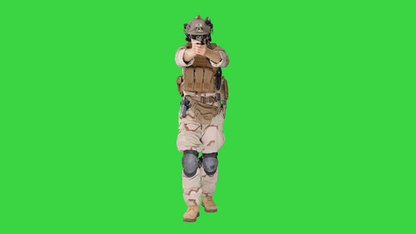Soldier Walking and Shooting From Hand Gun on a Green Screen, Chroma Key.