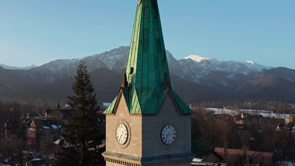 Close Up Of Clock Tower Of Holy Family Church In Krupowki, Zakopane, Poland. elevated shot