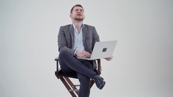 Businessman with laptop in studio. Studio portrait of businessman holding laptop