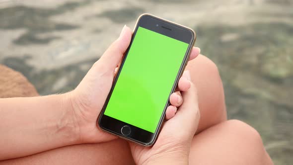 NICE, FRANCE - JULY 2017 Greenscreen tablet in woman hands