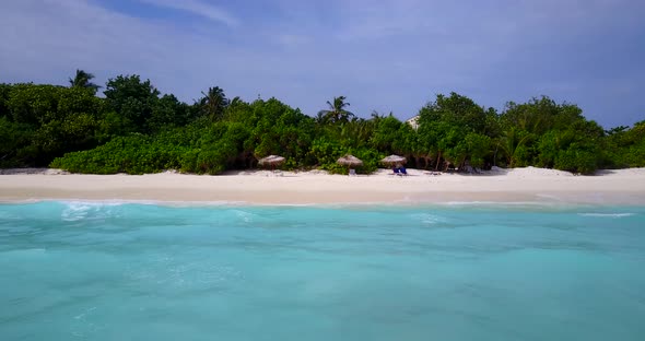 Luxury fly over tourism shot of a white sand paradise beach and aqua turquoise water background in c