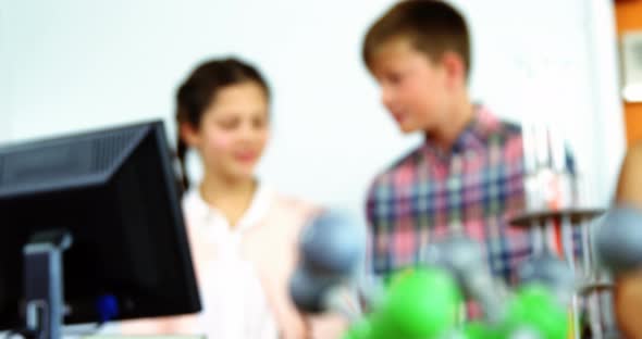 Schoolkids discussing in laboratory