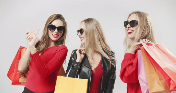 Happy Women with Red Shopping Bags