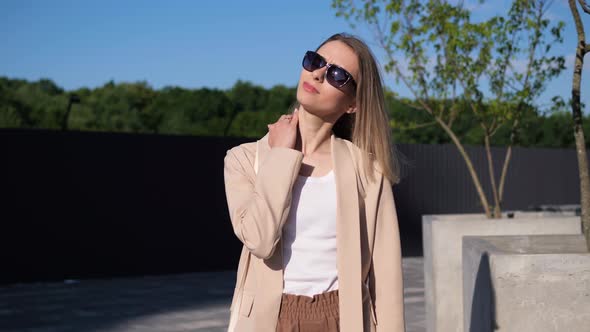 Woman Massaging Her Neck on the Street Near the Office Experiences Severe Pain