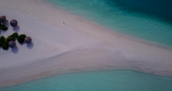 Natural fly over travel shot of a summer white paradise sand beach and aqua blue water background in