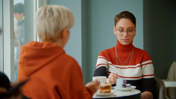 Young Girls Are Enjoying Their Slices of Cakes Together