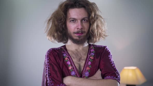 Camera Moving From Left To Right Around Young Bearded Caucasian Man with Long Curly Hair