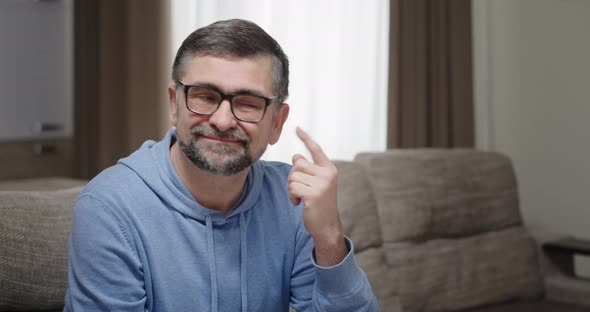 Senior Man with Glasses Thinks Scratching His Head Comes Up with Ideas Ways to Solve the Problem