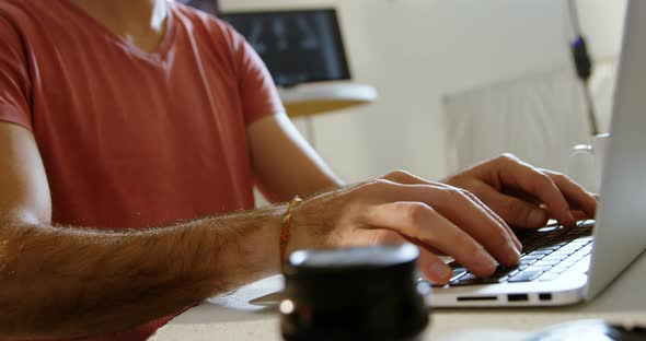 Male photographer using laptop 4k