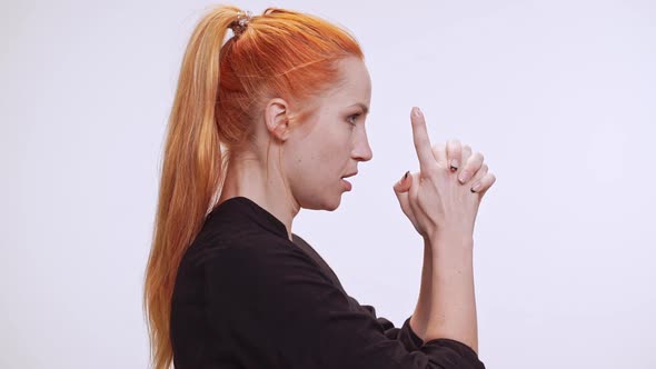 Profile View of Beautiful Caucasian Female with Colored Orange Hair Standing on White Background