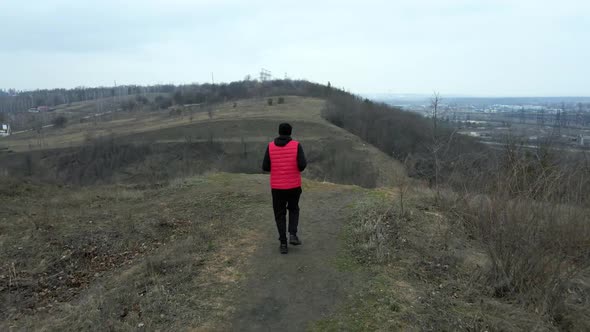 Aerial view drone Athletic man in red west running in the nature