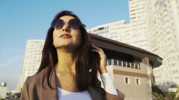 Beautiful Brunette Businesswoman In Business Clothes Walks In The City