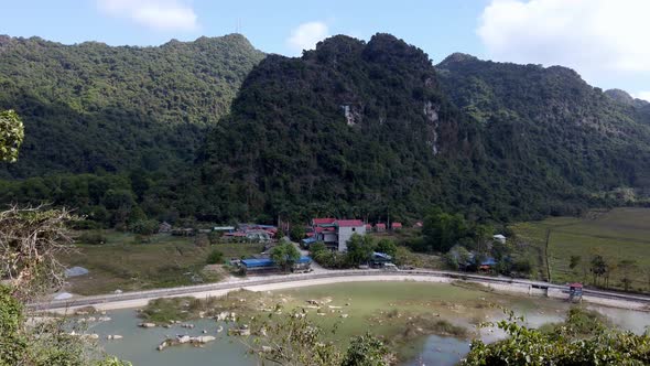 Viet Hai area panorama Cat Ba island Vietnam with Whisper Nature Bungalow buildings, Pan right revea