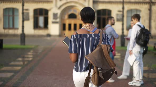 Back View African American Confident Young Woman Walking in Slow Motion to College Campus Passing