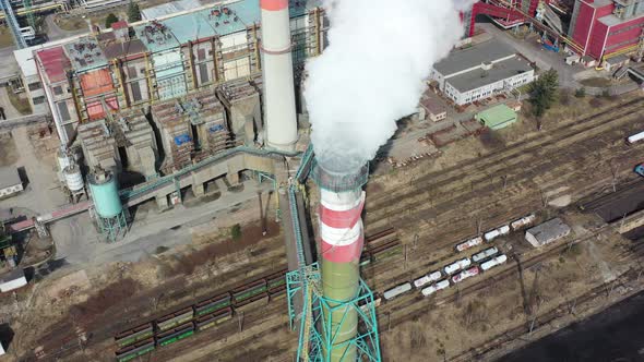 Aerial view of flue gas stack, coal fired thermal power plant and air pollution, toxic gas goes into