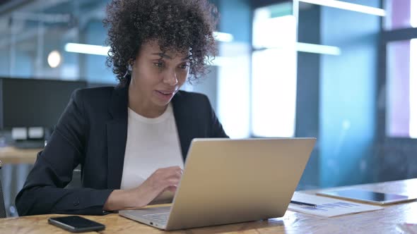 Successful Businesswoman Celebrating with Fist at Work