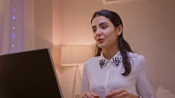 Happy Indian Young Woman Communicating By Conference Call Speak Looking at Computer at Home Office