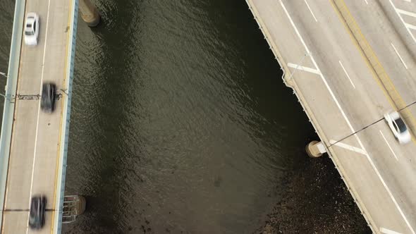 A top down shot of the East River shore below the Throgs Neck Bridge. The stoney shore between two e