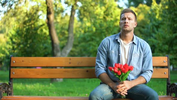 Man With Bunch of Flowers Tired of Waiting Girlfriend, Walking Away, Bad Date