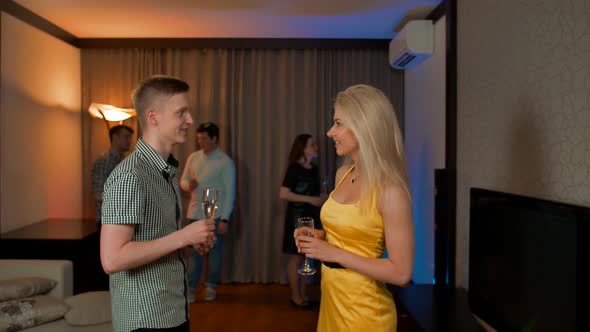 Young Couple Meet Flirting at Glamorous Party Drinking Champagne Cocktail.