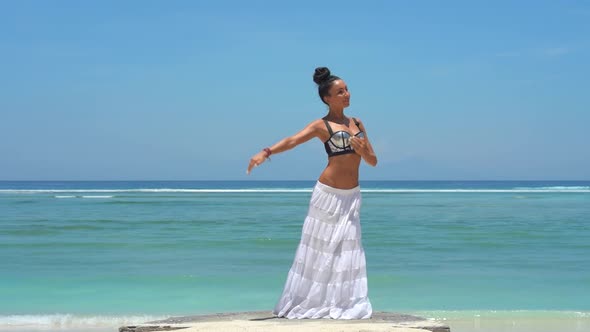 Gorgeous Girl in Long Skirt Dancing Meditating Elegance Moves Spiritual Dance in Front of Wavy Ocean