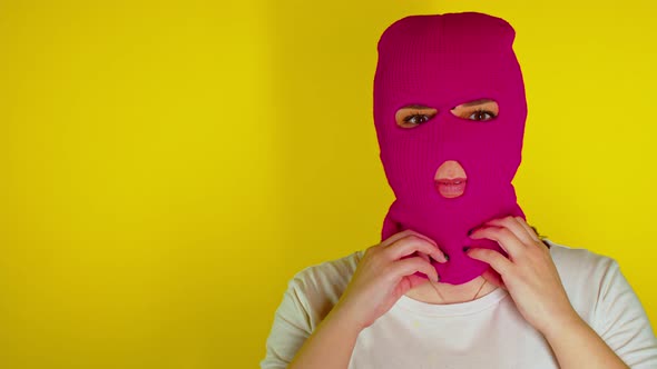 Close Up of Unrecognizable Person in Pink Balaclava on Yellow Background