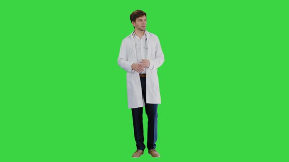 Male Doctor Talking To Camera Explaining Something on a Green Screen, Chroma Key.