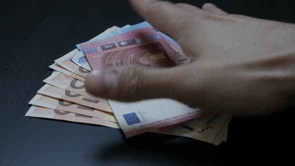 Human hand taking Euro   currency debts or deposits from table slow-mo 1080p HD video - Slow motion 