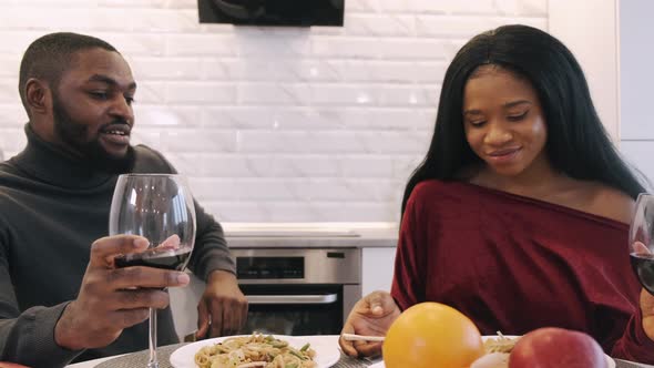 Young Couple Having Dinner at Home and Celebrating Saint Valentine