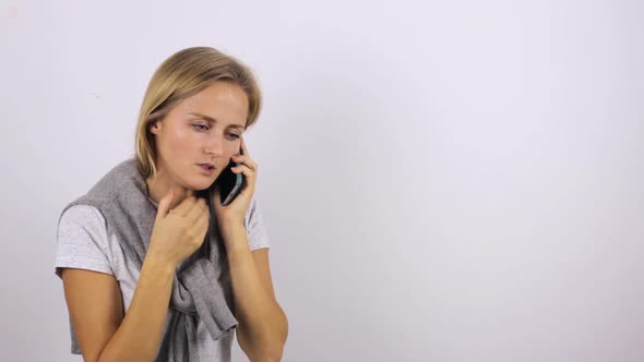 Young Woman Calls an Ambulance By Mobile Phone. Illness and General Malaise