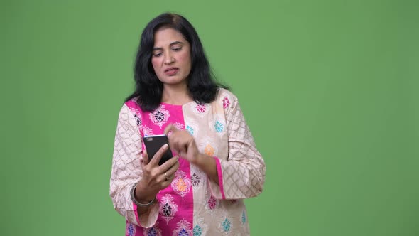 Mature Serious Indian Woman Using Phone While Getting Bad News