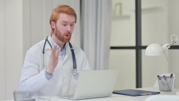 Video Chat on Laptop By Redhead Male Doctor