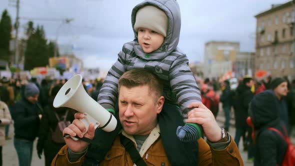 Father with Sitting on Shoulders Kid