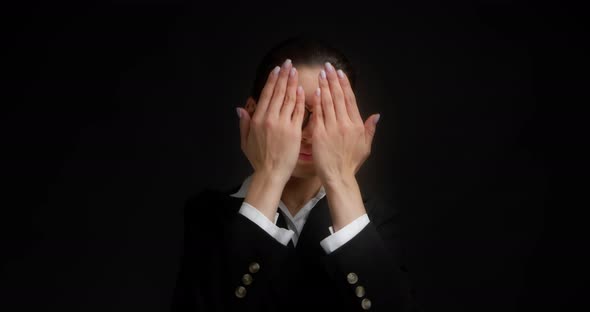 Business Woman Covers Her Face with Her Palms Does Not Want to Watch the News