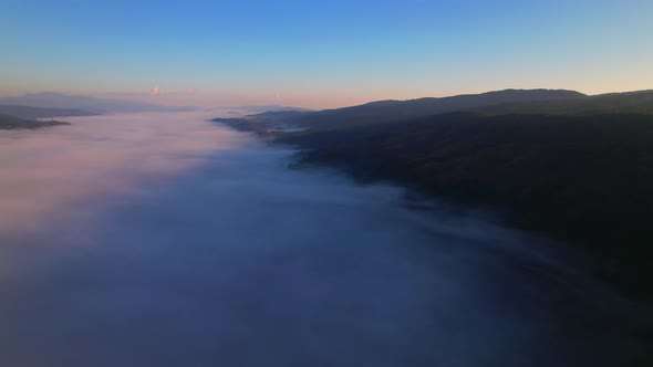 4K Drone Flying through the clouds at dusk or dawn. Aerial top cloudscape