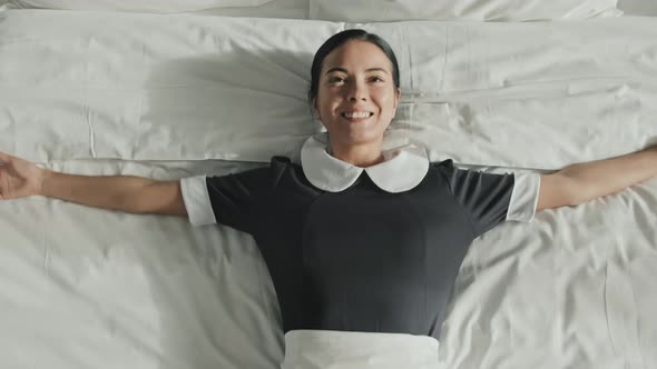 Housekeeper Resting on Bed after Work