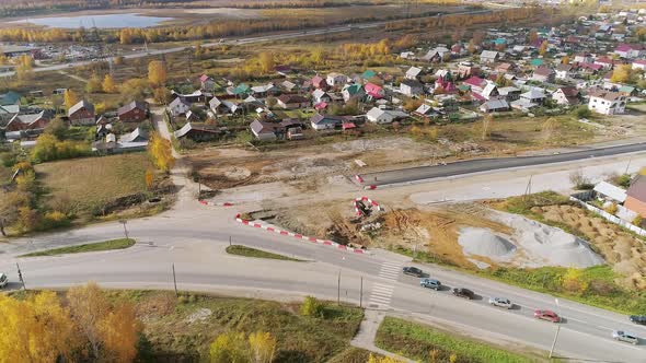 Aerial view of Repair of the road at the entrance to the city in Residential area. 38